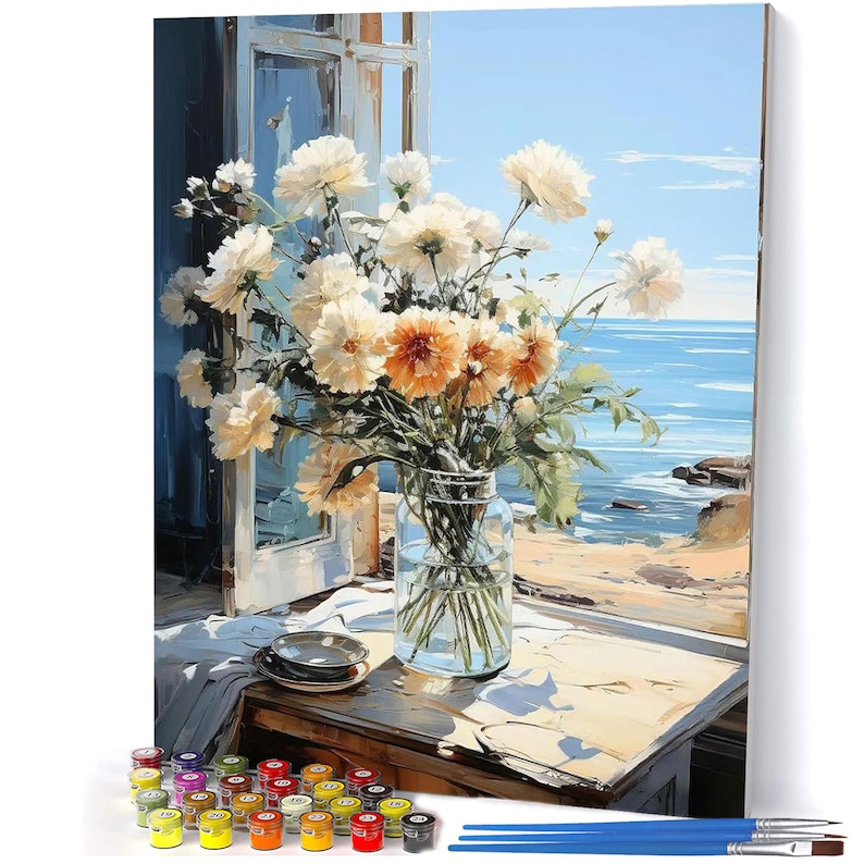 May include: A paint-by-numbers kit featuring a floral still life with a coastal view. The artwork depicts a bouquet of white and orange flowers in a glass jar on a wooden table near an open window. Includes paint pots and brushes.