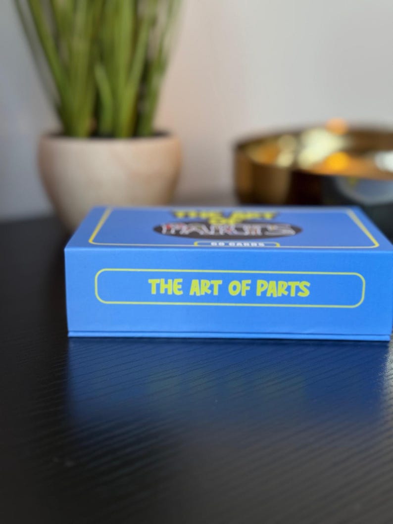 May include: Blue box with the text "The Art of Parts" on the front. The box is for a game called "The Art of Parts" and has a yellow and black design.