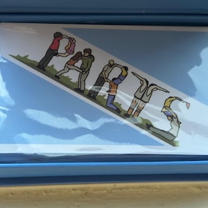 May include: A blue card with a white border and a graphic of people forming the word "PARIS" in a line. The people are wearing different colored clothing and are standing on a green grassy area. The background is a light blue sky with white clouds.