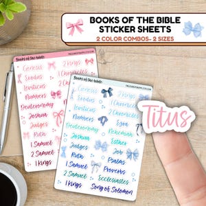 May include: Two sticker sheets with the names of the books of the Bible, in pink and blue, with bow accents. The text "Books of the Bible Sticker Sheets" is at the top. A sticker with the name "Titus" is on a finger.