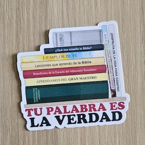 May include: A sticker with a stack of books and the text "TU PALABRA ES LA VERDAD" in black and red lettering. The books have Spanish titles, including "LA BIBLIA", "EJEMPLOS DE FE", and "APRENDAMOS DEL GRAN MAESTRO".