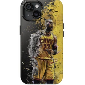 May include: A black and yellow iPhone case featuring a graphic of a basketball player wearing a Cleveland Cavaliers jersey with the number 23. The background is a yellow and black splatter design.