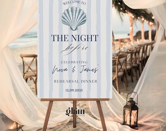 May include: A welcome sign for a rehearsal dinner, featuring a seashell illustration and text on a blue and white striped background. The sign reads "Welcome to The Night Before Celebrating Nora & James Rehearsal Dinner 12.09.2025."