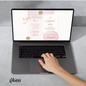 May include: A dark gray laptop displaying a digital baby shower invitation in shades of pale pink and white. The invitation features a ribbon, wax seals, and text including "Please join us for a baby shower honoring Nova Elis" and "11 August 2026".