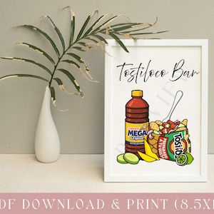 May include: A framed print with the text "Tostiloco Bar" above an illustration of a bottle of chamoy sauce, a bag of Tostitos chips, and lime slices. The print is in a white frame and is 8.5 x 11 inches.
