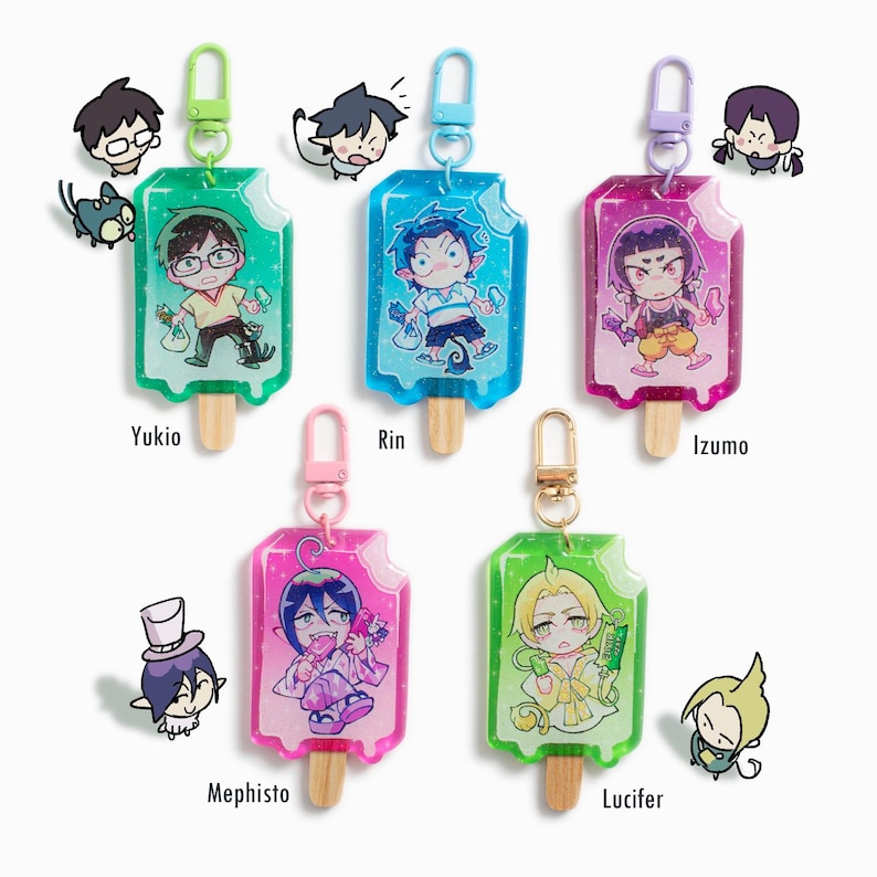 Colorful popsicle shaped acrylic keychains with glitter epoxy finish and a real wooden popsicle stick! Chibi characters are drawn admiring their own popsicle design. From left to right: Yukio, Rin, Izumo, Mephisto, Lucifer