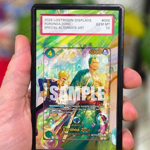 May include: A trading card featuring Roronoa Zoro from the "One Piece" series, graded as GEM MT 10. The card has a colorful illustration with the word "SAMPLE" across the front. The card is in a black protective case.