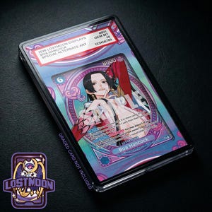 May include: A graded Boa Hancock trading card in a clear plastic slab. The card features an anime-style character with black hair, wearing a white outfit with red accents. The label reads 2026 LOSTMOON DISPLAYS, BOA HANCOCK, SPECIAL ALTERNATE ART, GEM MT 10.