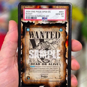 May include: A graded trading card featuring Buggy from One Piece. The card has a "WANTED" poster design with the text "DEAD OR ALIVE". The card is encased in a black holder with a "GEM MT 10" grade.