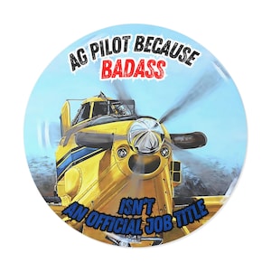 May include: Round sticker featuring a yellow crop duster plane with blue stripes and a spinning propeller. Text reads "AG PILOT BECAUSE BADASS ISN'T AN OFFICIAL JOB TITLE" in black and blue.