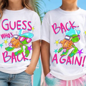 May include: Two white t-shirts featuring a cartoon turtle wearing a blue cap, pink sunglasses, and a brown backpack. The left shirt displays the text GUESS WHO'S BACK in pink, while the right shirt displays the text BACK AGAIN in pink.