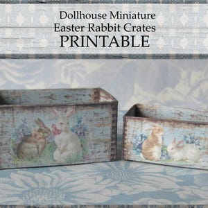 May include: Two miniature rectangular crates with a distressed, aged appearance. The crates feature illustrations of rabbits and floral elements on a light blue background. The word "PRINTABLE" is displayed above the crates.