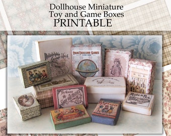 May include: A collection of miniature toy and game boxes, printed with vintage designs. The boxes are made of cardboard and feature various colors and patterns, including red, blue, green, and white. The boxes are labeled with names like "Philadelphia Carriage Shop" and "The Game of Star Authors".