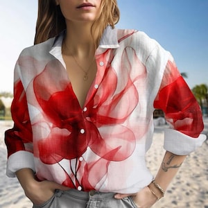 May include: White button-down shirt with a large red floral design. The long-sleeved shirt features a collared neckline and is made of a lightweight fabric. The red floral pattern is semi-transparent, creating a layered effect.