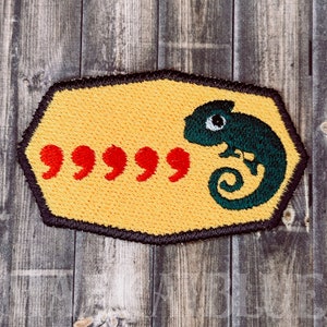 May include: Yellow embroidered patch with a green chameleon and five red quotation marks.