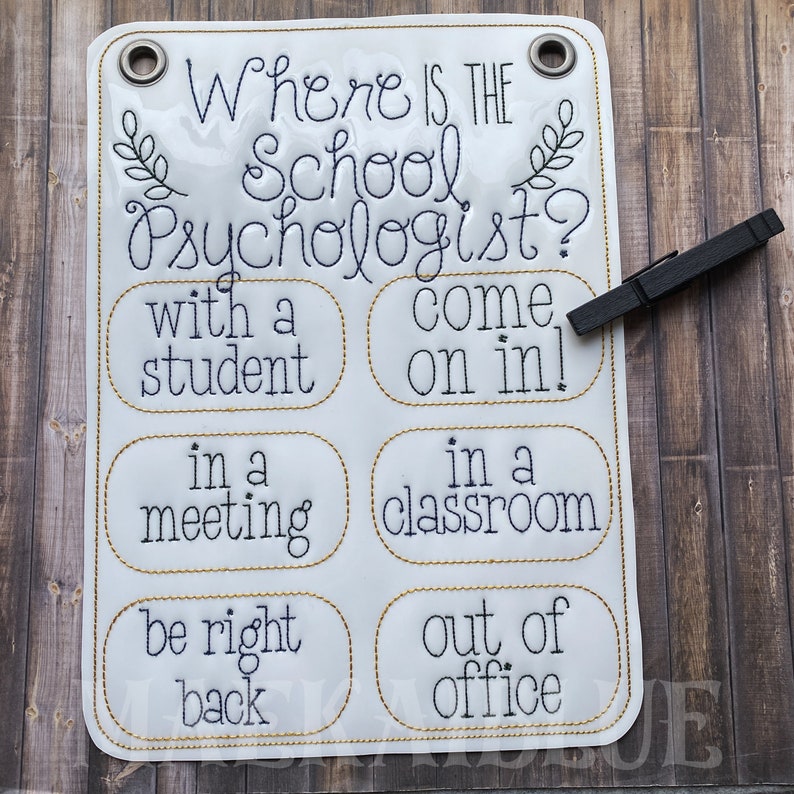 May include: White sign with gold trim and black text that reads "Where is the School Psychologist?" with options to choose from: "with a student", "in a meeting", "be right back", "come on in!", "in a classroom", "out of office".