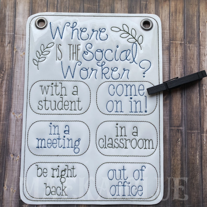 May include: White sign with blue text that reads "Where is the Social Worker?" with six options: "with a student", "come on in!", "in a meeting", "in a classroom", "be right back", and "out of office".