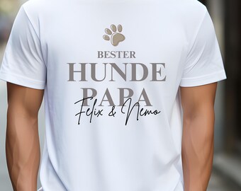 May include: White t-shirt with the text "BESTER HUNDE PAPA Felix & Nemo" in grey and a paw print graphic.