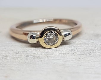 Engagement ring in red/rose gold, yellow gold setting with diamond, white gold adornment