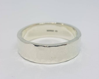 4mm wide hammered flat wedding ring in recycled 9ct white gold.