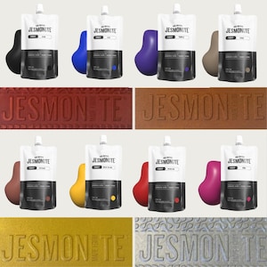 May include: A selection of Jesmonite pigment pouches in colours such as black, blue, purple, and brown. The image also shows Jesmonite samples in red, brown, and gold, with the brand name embossed. The pouches have a white top and a black bottom.