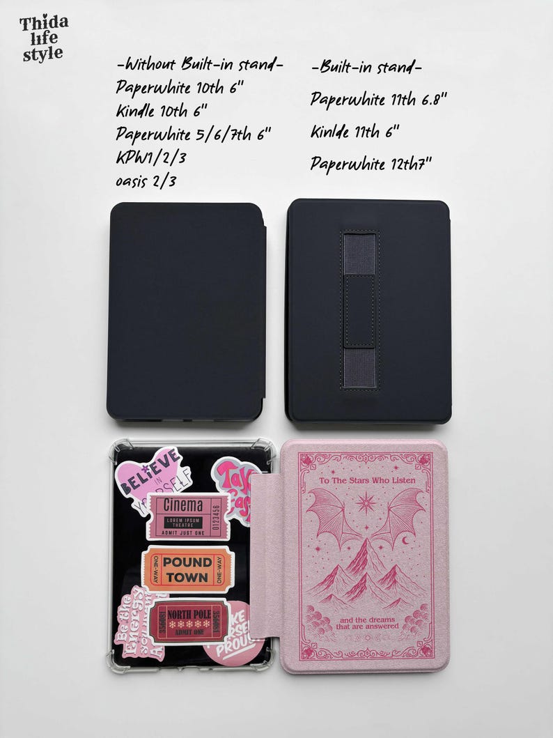 May include: A collection of e-reader cases in black and pink. One case is open, displaying a pink cover with a mountain and bat wing design. The other cases are closed, showing a solid black exterior. Text on the cases includes "Believe in Yourself" and "To The Stars Who Listen."