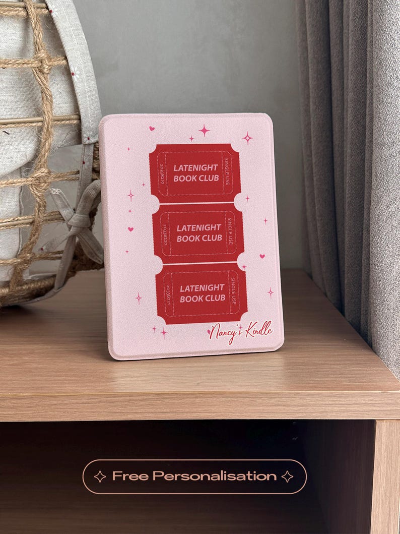 vintage and vibrant Kindle case featuring a soft pink background with three bold red ticket-style designs labeled “LATENIGHT BOOK CLUB” and marked “SINGLE USE.” Decorative pink hearts and sparkles add a whimsical, cozy vibe—perfect for book lovers who enjoy getting lost in stories after dark.