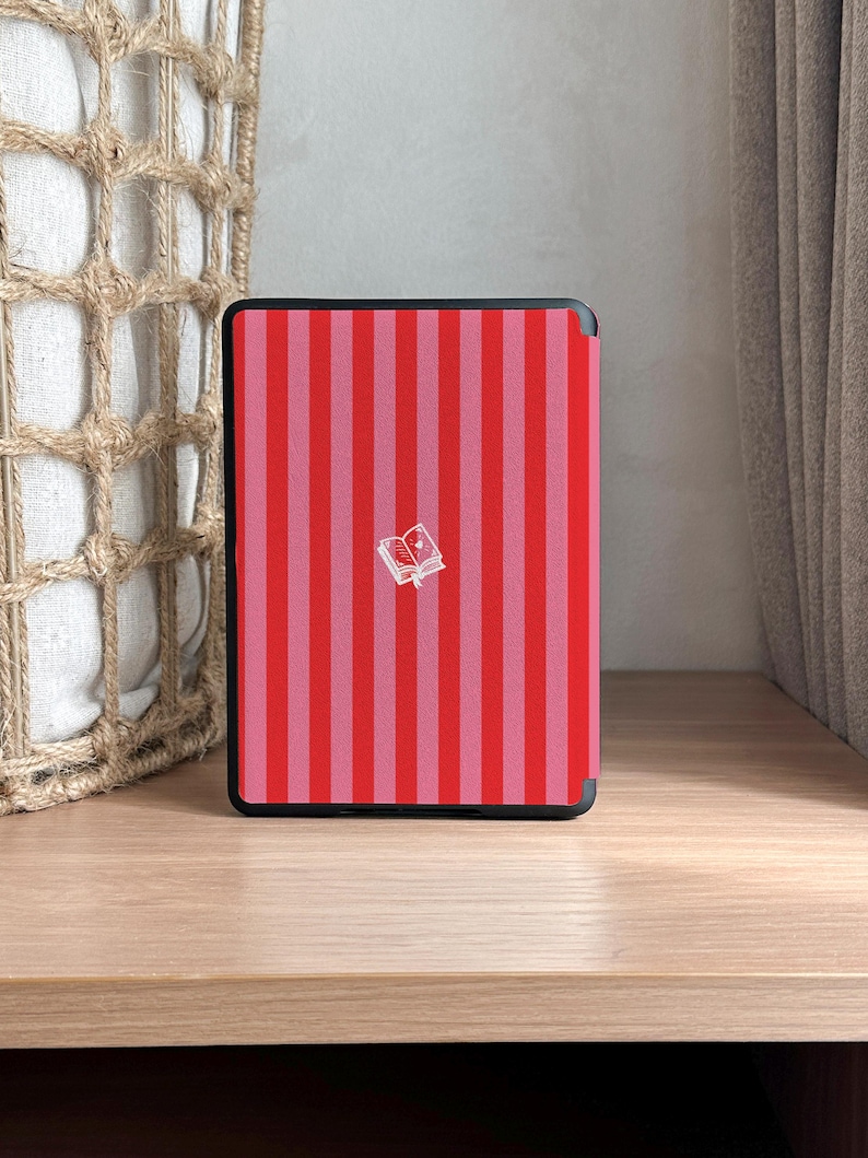 May include: A red and pink striped e-reader cover with a small white book icon in the center.