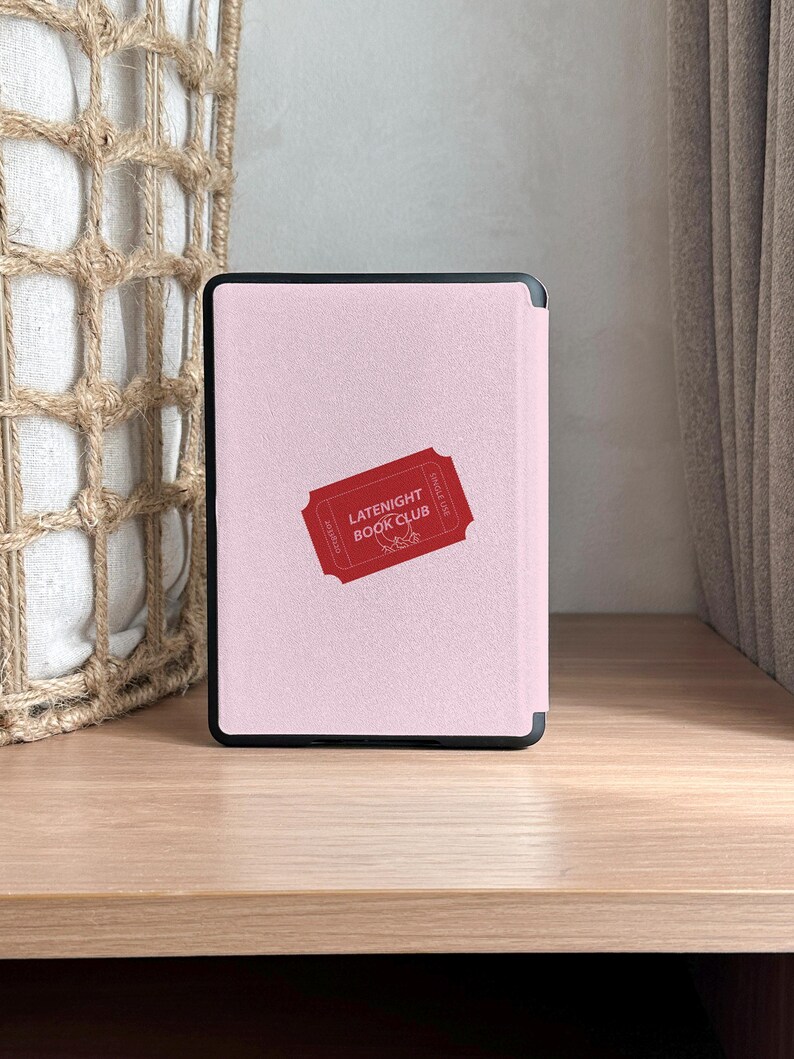 vintage and vibrant Kindle case featuring a soft pink background with three bold red ticket-style designs labeled “LATENIGHT BOOK CLUB” and marked “SINGLE USE.” Decorative pink hearts and sparkles add a whimsical, cozy vibe—perfect for book lovers who enjoy getting lost in stories after dark.