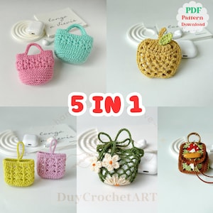 May include: A collection of five crochet cases in various shapes and colors, including a pink tote bag, a teal handbag, a yellow apple, a green net bag with flowers, and a brown mushroom backpack. The text "5 IN 1" is displayed in red.