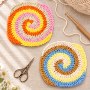 May include: Two round crochet coasters featuring a spiral pattern. One coaster displays alternating rings of cream, pink, orange, and yellow yarn. The second coaster features alternating rings of cream, light blue, and brown yarn.