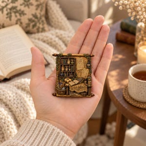 May include: A rectangular, scroll-shaped decorative plaque featuring a detailed, miniature three-dimensional scene of a study. The scene includes a wooden bookshelf filled with small bottles and books, a desk with an open book, and a basket of dried herbs.