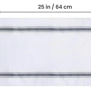 Size diagram of the white bread tea towel with black stripes, measuring 25 inches / 64 cm wide by 15 inches / 38 cm tall.