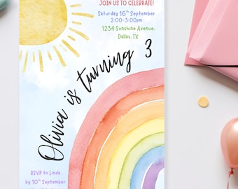 May include: A watercolor birthday invitation with a rainbow, sun, and text that reads "Olivia is turning 3." The invitation includes event details: date, time, and location. Pastel-colored envelopes and a balloon surround the invitation.