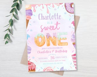 May include: A watercolor invitation for a first birthday celebration. The design features the text "Charlotte is a sweet ONE" with colorful illustrations of donuts, cupcakes, and ice cream cones. The invitation includes event details.