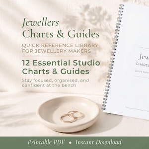 May include: A white spiral-bound book titled "Jewellers Charts & Guides" with text that reads "Quick Reference Library for Jewellery Makers". A small, off-white ceramic dish holds two gold rings. The image also includes the text "12 Essential Studio Charts & Guides".