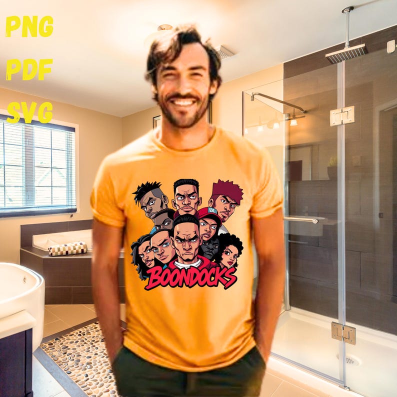 May include: Mustard yellow t-shirt featuring a graphic of several cartoon faces with the word "BOONDOCKS" in red. The shirt has short sleeves and a crew neck. The image also includes the text "PNG", "PDF", and "SVG".