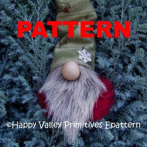 May include: A handmade gnome doll with a long, grey faux fur beard and a red bottom. The gnome wears a green hat with a snowflake and a small bell. The word "PATTERN" is displayed in red letters.
