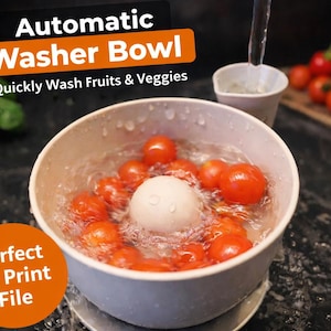 May include: An automatic washer bowl washing cherry tomatoes. The bowl is white and has a white sphere in the center. The text on the image says "Automatic Washer Bowl" and "Quickly Wash Fruits & Veggies".