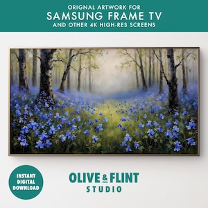 May include: A digital painting of a misty forest scene with a field of blue flowers in the foreground. The trees are tall and slender, and the light is soft and diffused. The painting is in a digital frame, and the text "OLIVE & FLINT STUDIO" is visible at the bottom.