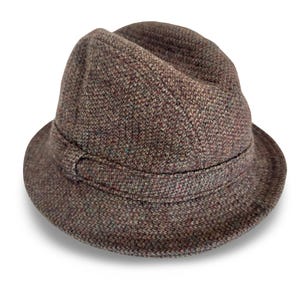 May include: A brown tweed fedora hat with a short brim and a band around the crown. The hat has a textured appearance with flecks of colour throughout the fabric. A classic style.