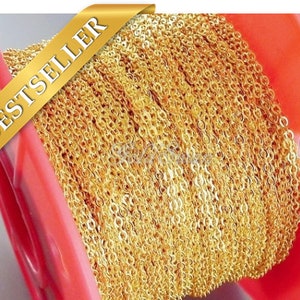 May include: A spool of gold-colored chain, wound tightly. The chain is made of small, linked circles. The spool is red and has a label that says "BESTSELLER".