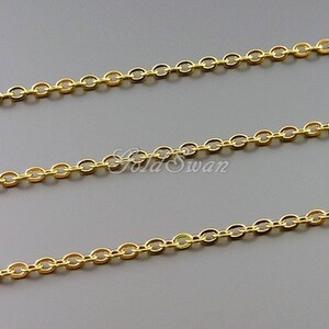 May include: Gold chain with oval links. The chain is shown in three rows on a gray background.