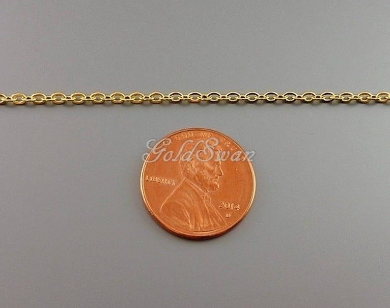 May include: A gold chain necklace, approximately the size of a US penny.
