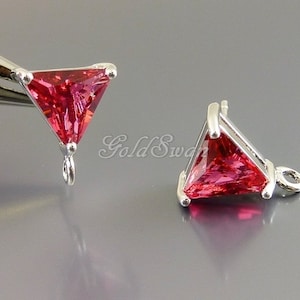 May include: Two silver triangle shaped charms with a pink gemstone in the center. Each charm has a loop for attaching to a necklace or bracelet.