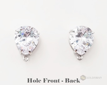 May include: A pair of silver teardrop-shaped earrings with clear cubic zirconia stones. The earrings have a small loop at the bottom for attaching to a chain or other jewelry.