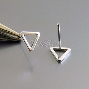 May include: A pair of silver triangle stud earrings. The earrings are simple and minimalist, with a hollow triangle design.