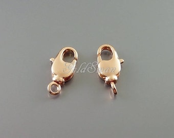 May include: Two gold-toned lobster claw clasps, a type of jewelry finding used for attaching chains or cords.