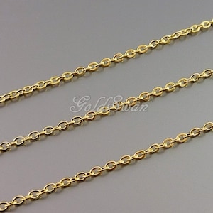 May include: A gold chain necklace with a delicate, oval-shaped link design. The chain is shown in three rows, showcasing its length and detail.