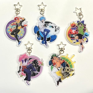May include: Five anime-style acrylic keychains with star-shaped clasps. Each keychain features a different character design within a circular frame. The characters are depicted in various action poses, with vibrant colors and detailed artwork.